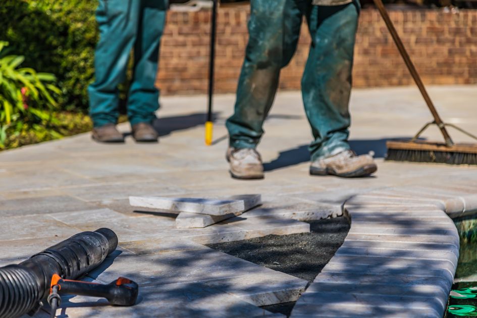 GreenScape team laying a stone patio in a Leeds garden